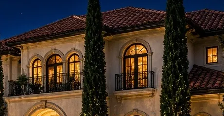 Illustration detail: cream stucco facade with arched windows, balconies and a tile roofline