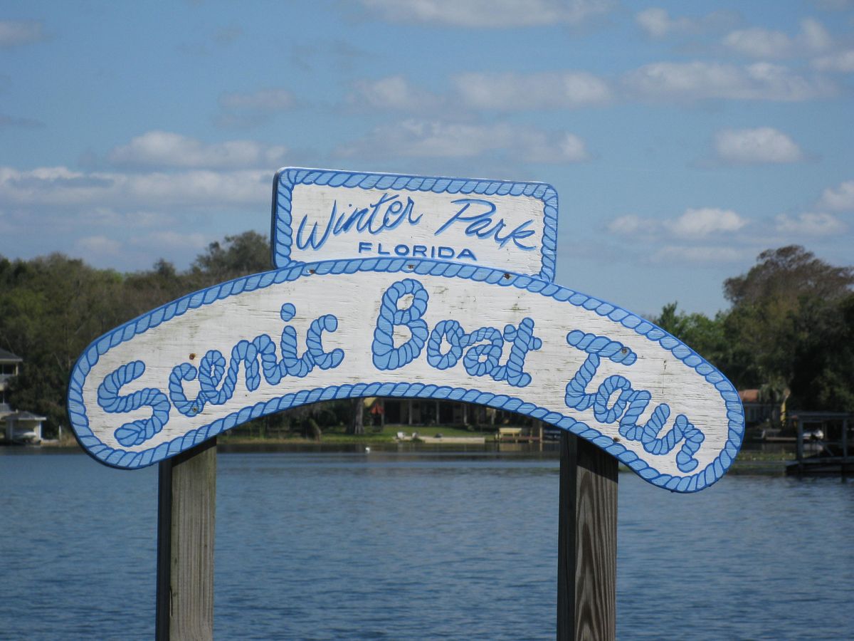 Winter Park Scenic Boat Tour sign at the lake's edge
